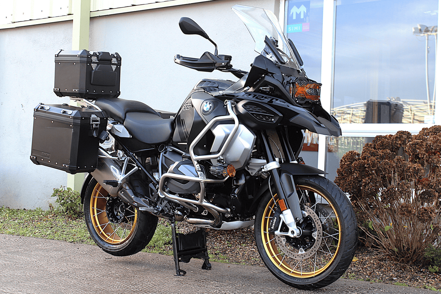 Black bmw gs motorcycle with gold wheels on centre stand