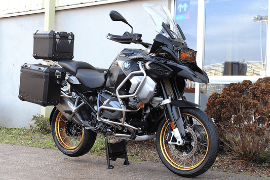 Black bmw gs motorcycle with gold wheels on centre stand