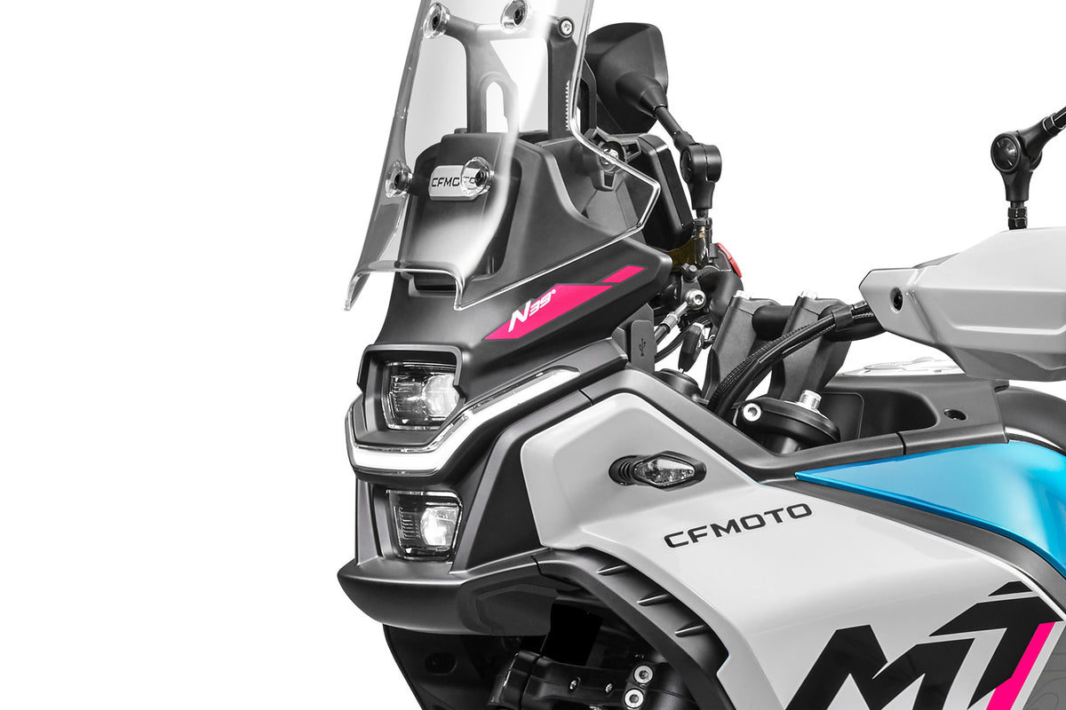 Close-up of a CFMOTO 450MT front-end, headlight and windshield on a white background