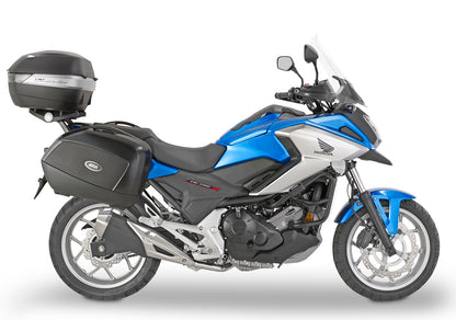Blue and black motorcycle with a top box on a white background